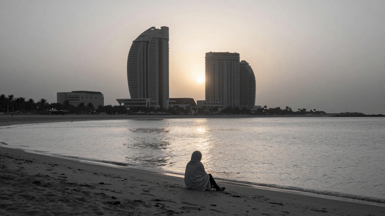 Solitary figure on Al Sufouh Beach at dawn, facing the ocean as sunlight reflects on still water.
